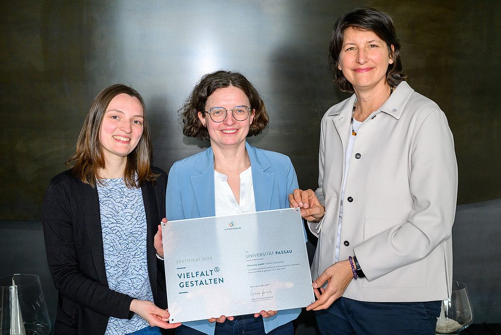 Andrea Frank, stellvertretende Generalsekretärin des Stifterverbandes überreicht Dr. Claudia Krell und Regine Fahn das Zertifikat Vielfalt gestalten.