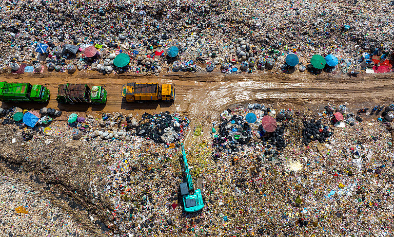 Garbage trucks over landfill