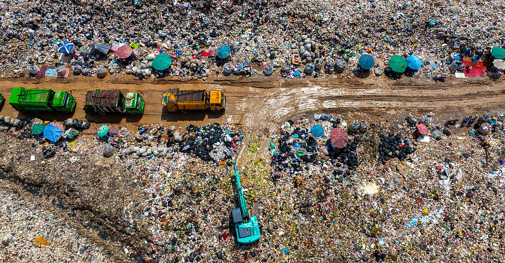 Garbage trucks over landfill