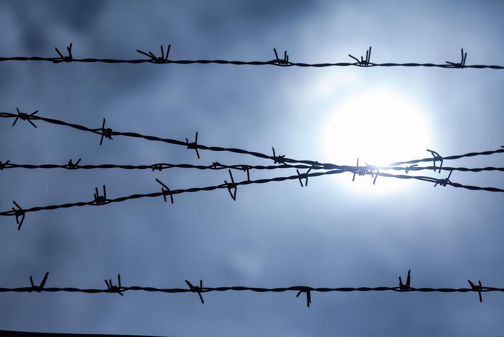 Cloudy sky, seen through a barbed wire