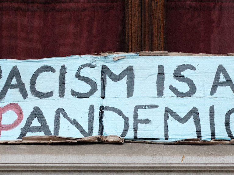 Demo-Plakat: Racism is a pandemic