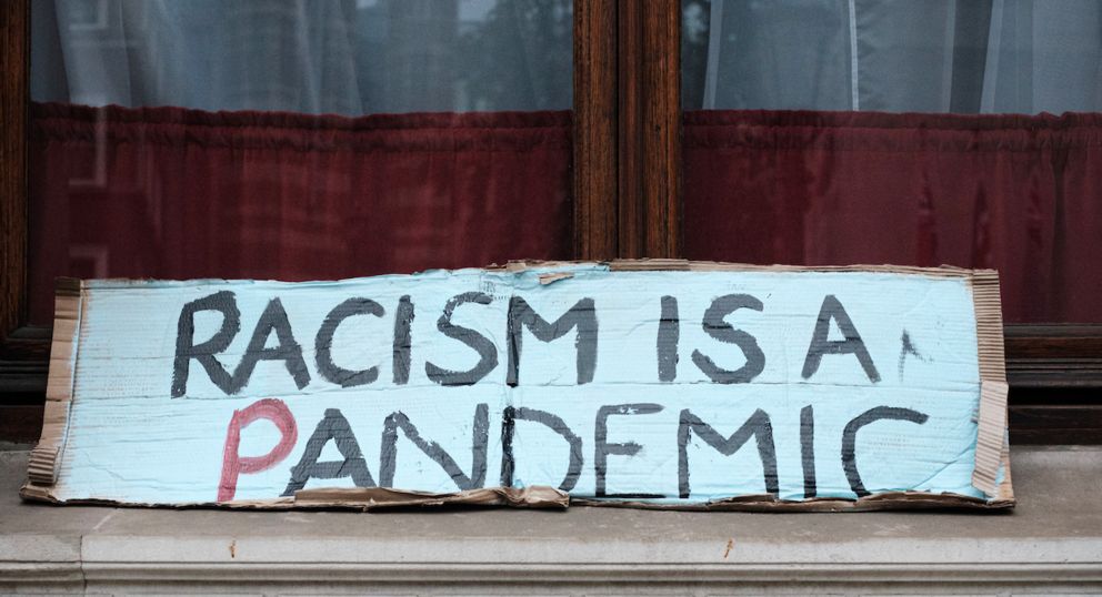 Demo-Plakat: Racism is a pandemic