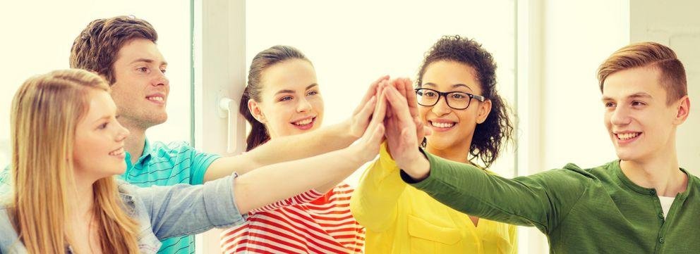 Group of students give each other a high five