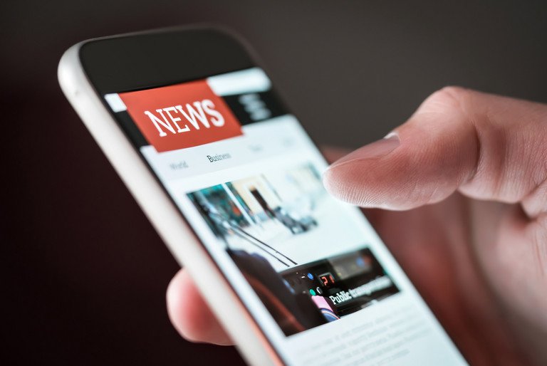 Mobile news application in smartphone. Man reading online news on mobile phone