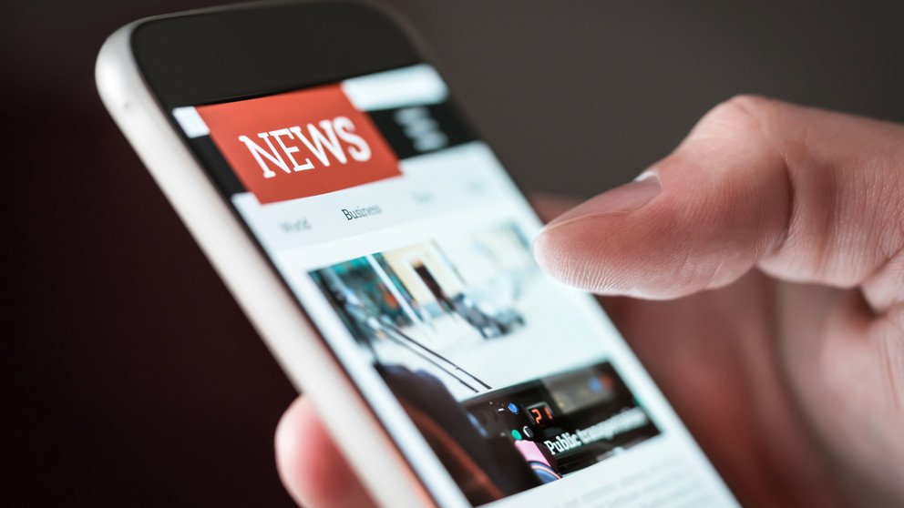 Mobile news application in smartphone. Man reading online news on mobile phone