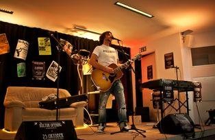 A band playing on the Kulturcafete stage (with posters)