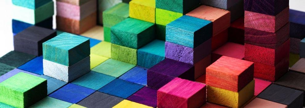 Spectrum of stacked multi-colored wooden blocks. Background or c