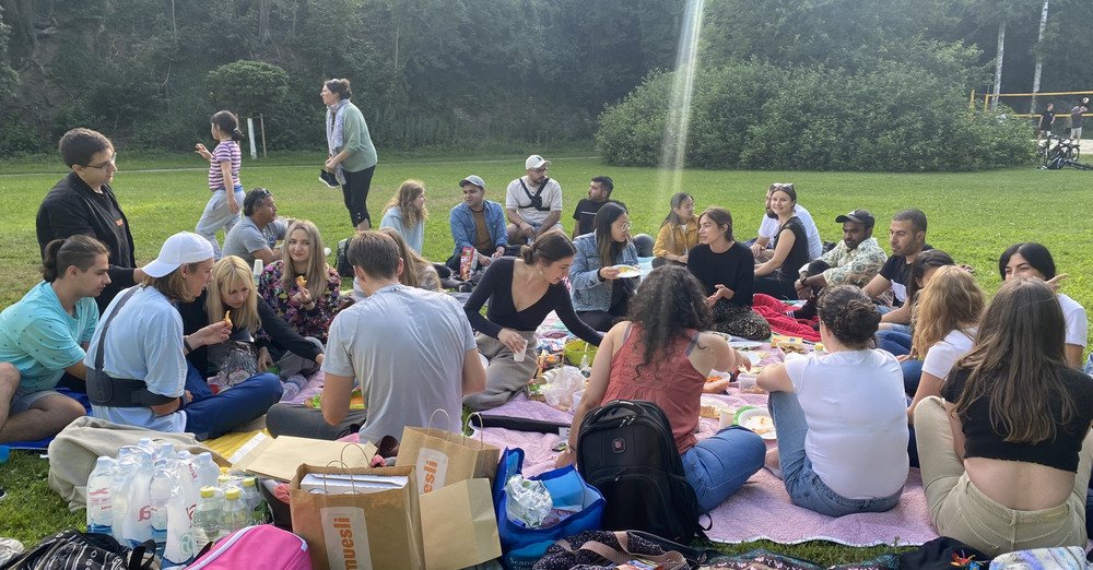 Studierende bei einem Picknick auf einer Wiese