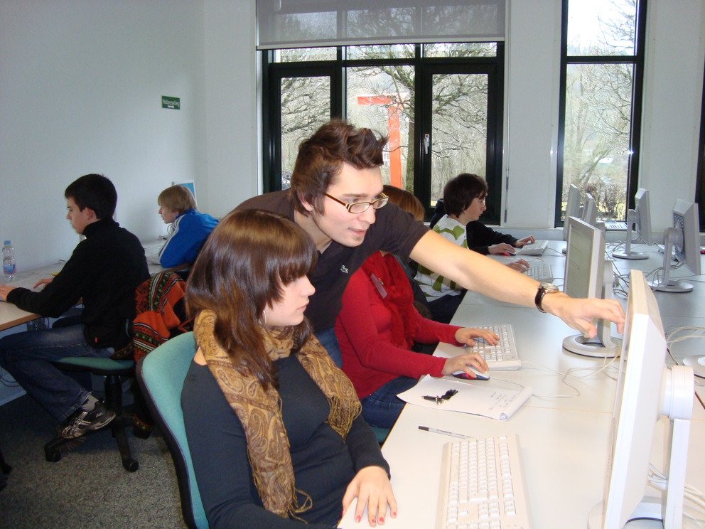 Sch&uuml;ler und ein Betreuer bei der Arbeit.