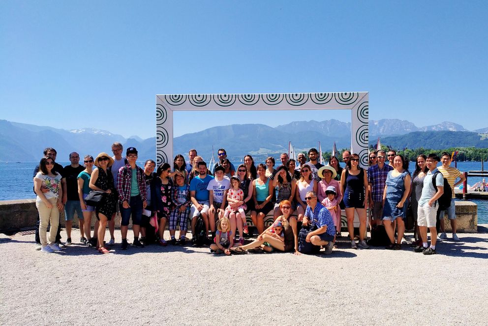 Participants of a Welcome Centre Trip in front of a Mountain Range
