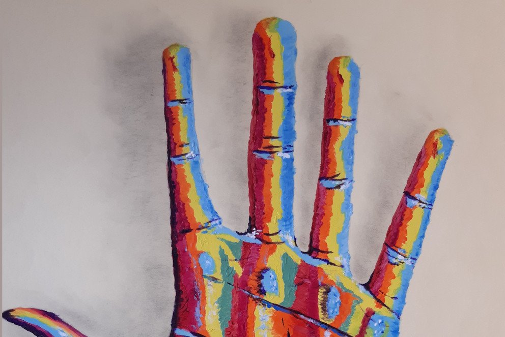 Painting of a hand in many colours
