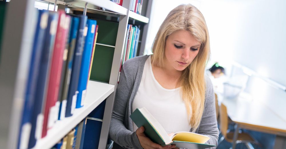 Student in the library with a book
