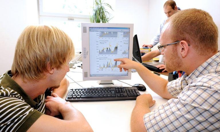 Academics in front of a desktop computer