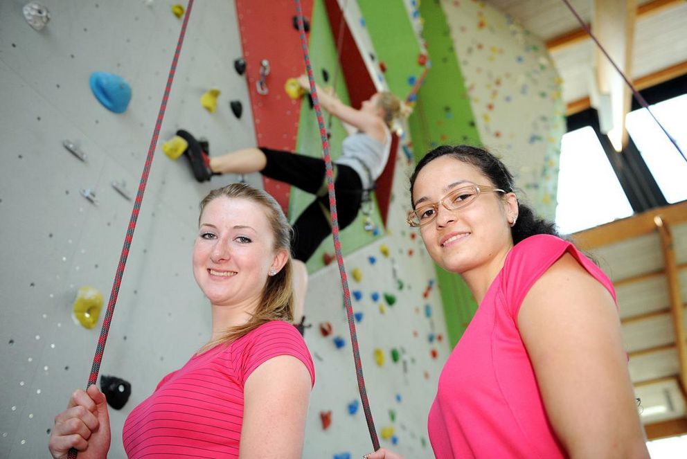 Young women at a climbing wall
