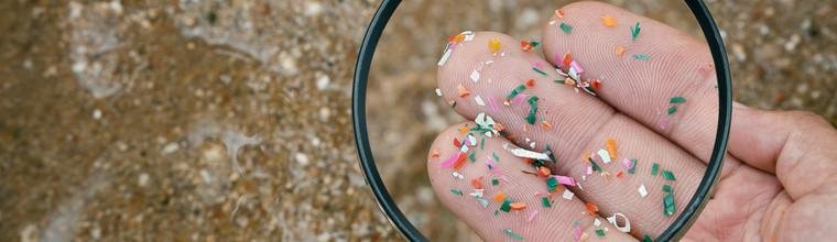 Close up side shot of microplastics lay on people hand. Concept of water pollution and global warming. Climate change idea. micro plastics concept in food and water or sea