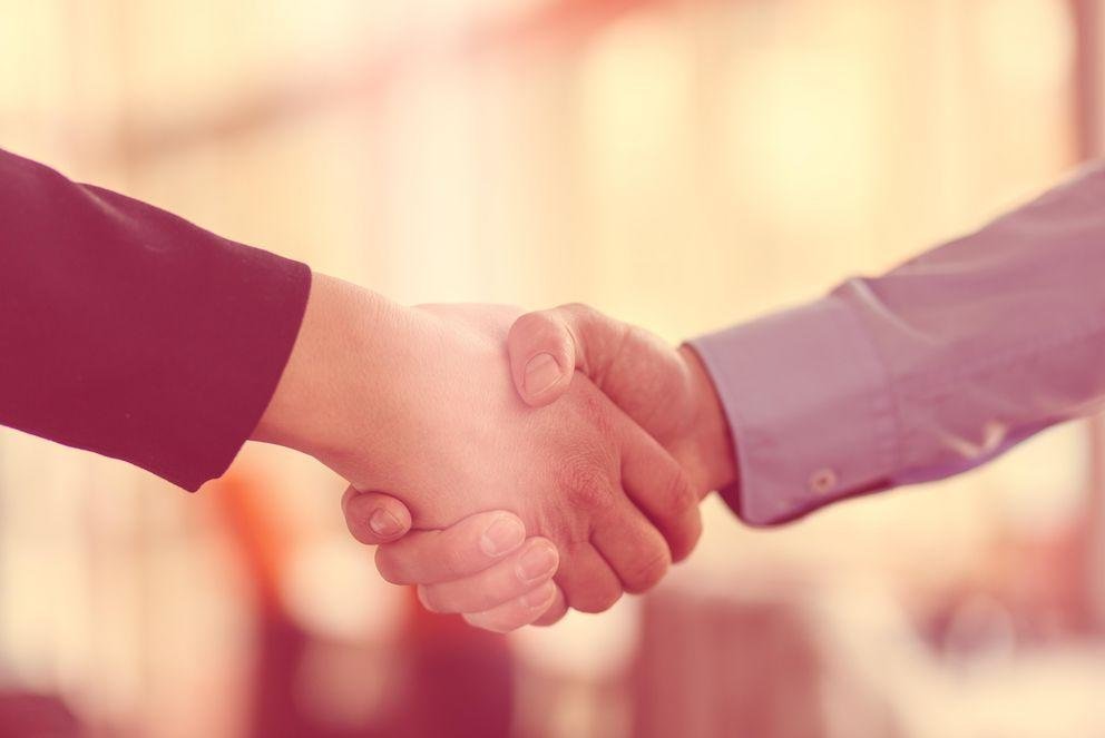 Handshake between african and a caucasian man.