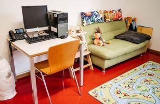 Desk with computer equipment and couch