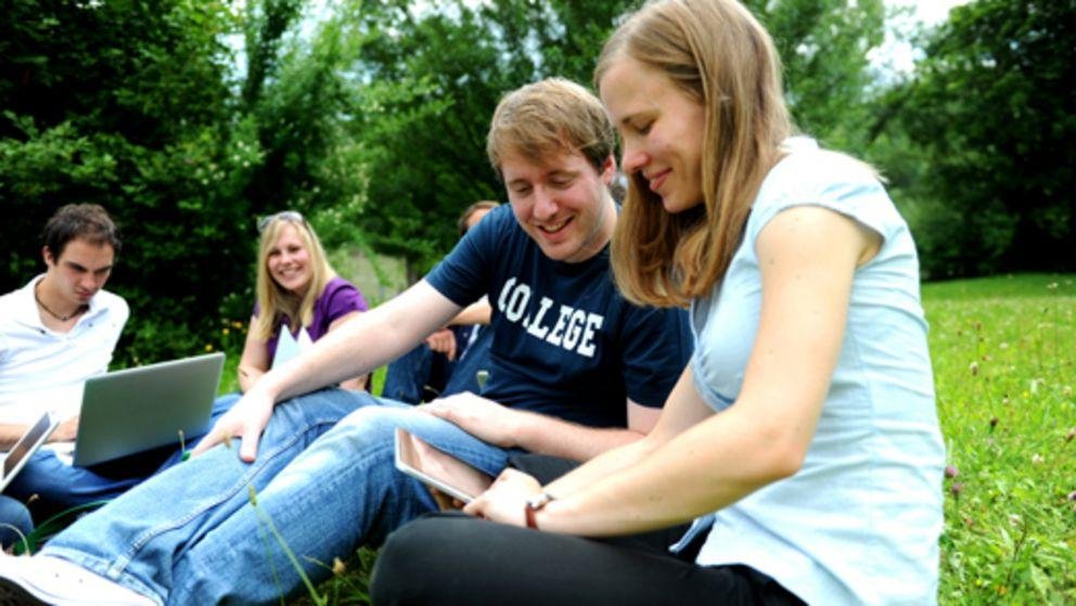 on the University campus Students with a notebook computer