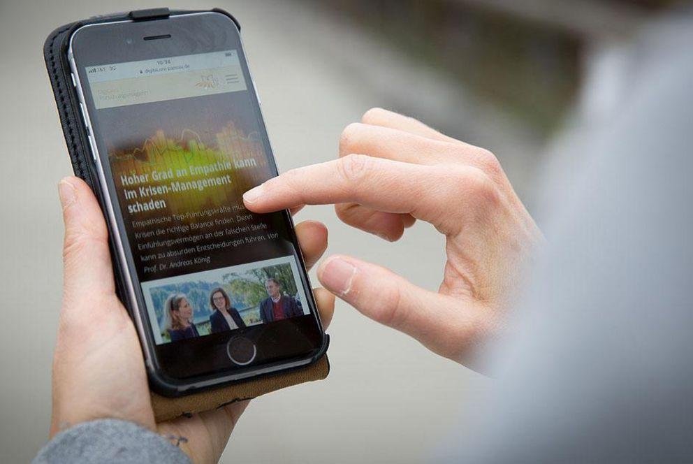 Student holds a smartphone in hands