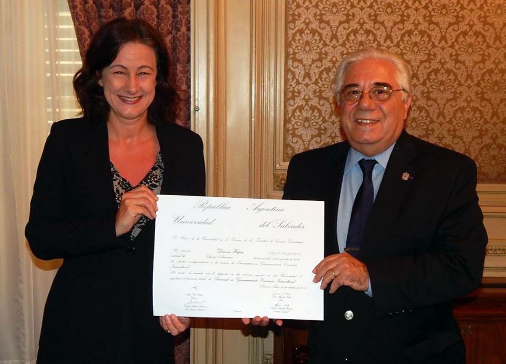 Juan Alejandro Tobías, Rector of Universidad del Salvador, hands the certificates for students who have earned their degrees under the first agreement to Ursula Reutner, Vice President for International Relations of the University of Passau.